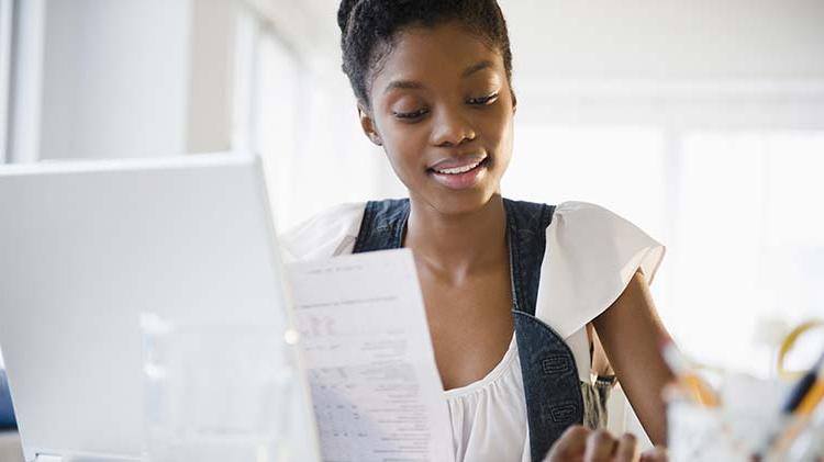 Woman closing her credit card after paying it off.